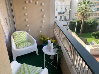 a balcony with a chair and a table at Charmant studio Croisette in Cannes