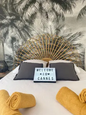 a bed with a welcome to the games sign on it at Studio Stella in Cannes