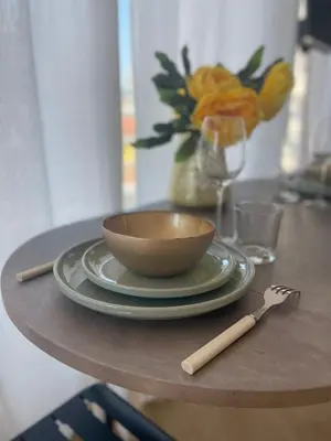 a table with a bowl and a plate and a fork at Studio Stella in Cannes