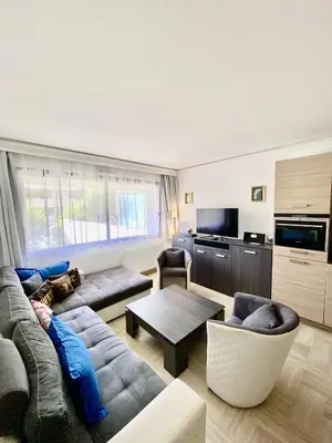 a living room with a couch and a table at Elegant studio MEN5335 in Cannes