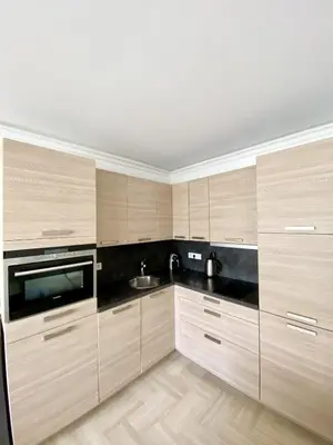 a kitchen with wooden cabinets and a sink at Elegant studio MEN5335 in Cannes