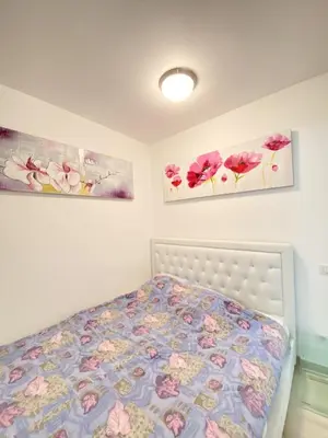 a bedroom with a bed with two paintings on the wall at Elegant studio MEN5335 in Cannes