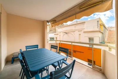 a blue table and chairs on a balcony at REF 1967 - Cannes Center - Apartment for rent in Cannes