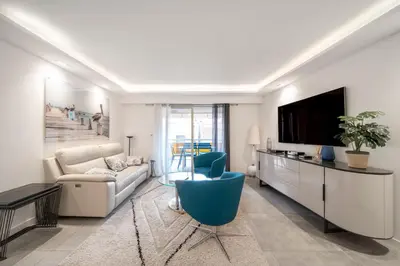a living room with a couch and a tv at REF 1967 - Cannes Center - Apartment for rent in Cannes