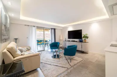 a living room with a couch and chairs and a television at REF 1967 - Cannes Center - Apartment for rent in Cannes