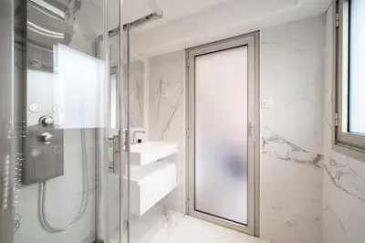 a bathroom with a shower and a glass door at REF 1967 - Cannes Center - Apartment for rent in Cannes
