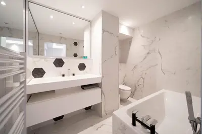 a white bathroom with a tub and a sink at REF 1967 - Cannes Center - Apartment for rent in Cannes