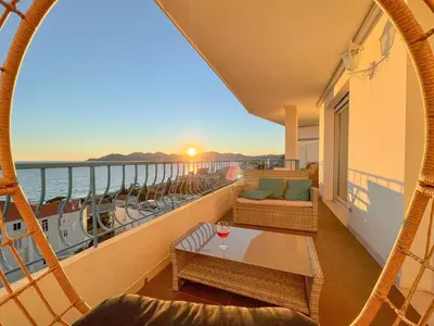 a balcony on a cruise ship with a table and chairs at Western Cannes - Panoramic View in Cannes