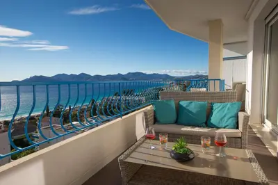a balcony with a table and a view of the ocean at Western Cannes - Panoramic View in Cannes