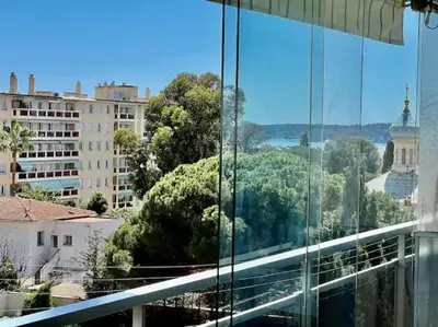 a view of a city from a window of a building at Grande terrasse vue dégagée mer en Basse Californie in Cannes