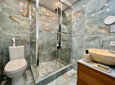 a bathroom with a shower and a toilet and a sink at Grande terrasse vue dégagée mer en Basse Californie in Cannes