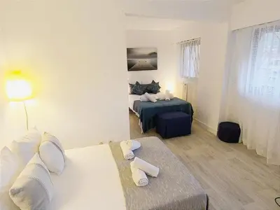 a hotel room with a bed and a table at Le 66 Carnot in Cannes