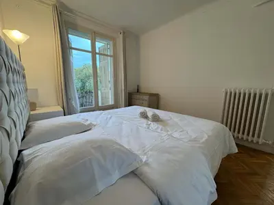 a white bed in a bedroom with a window at C070 Magnifique appartement au calme 2 Chambre centre in Cannes
