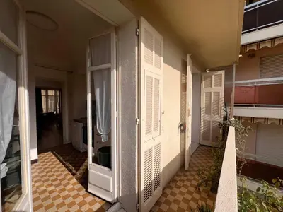 a hallway of a house with white doors and a tile floor at C070 Magnifique appartement au calme 2 Chambre centre in Cannes