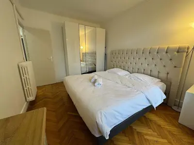 a bedroom with a large bed with white sheets at C070 Magnifique appartement au calme 2 Chambre centre in Cannes