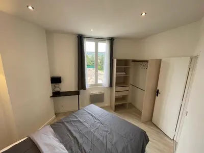 a small bedroom with a bed and a window at 2 pièces au calme in Cannes
