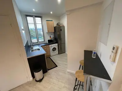 a small kitchen with a sink and a refrigerator at 2 pièces au calme in Cannes