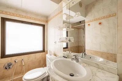 a bathroom with a sink and a toilet and a tub at LE CASANOVA avec balcon au cœur du centre-ville in Cannes
