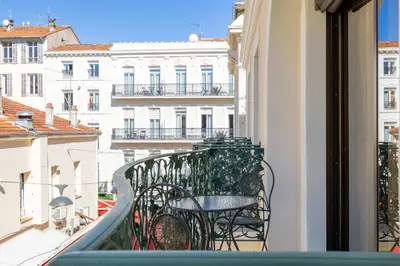 a balcony with a table and chairs on a building at LE CASANOVA avec balcon au cœur du centre-ville in Cannes