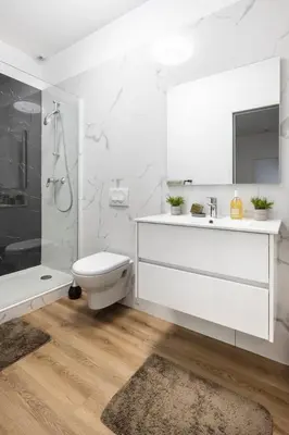a white bathroom with a toilet and a sink at Suite Carla - Superbe appartement à Cannes in Cannes