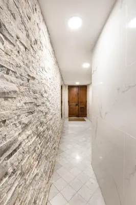 a hallway with a stone wall and a door at Suite Carla - Superbe appartement à Cannes in Cannes