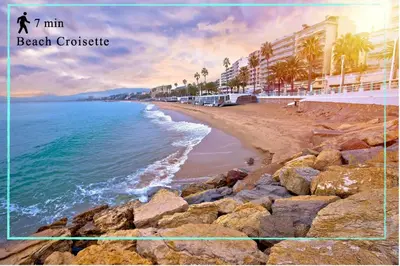 a picture of a beach with buildings and the ocean at Suite Carla - Superbe appartement à Cannes in Cannes