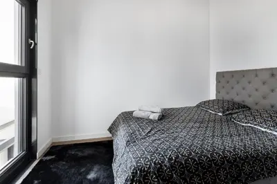 a bedroom with a bed with a gray comforter at Suite Carla - Superbe appartement à Cannes in Cannes
