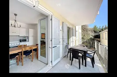 a kitchen and dining room with a table and chairs on a balcony at Nice & Cosy, 4 pers, 1 bedroom with balcony in Cannes