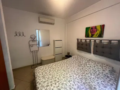 a bedroom with a bed and a painting on the wall at Nice & Cosy, 4 pers, 1 bedroom with balcony in Cannes