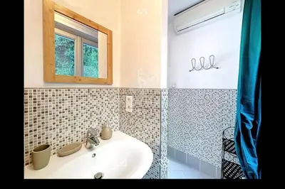 a bathroom with a sink and a mirror and a window at Nice & Cosy, 4 pers, 1 bedroom with balcony in Cannes