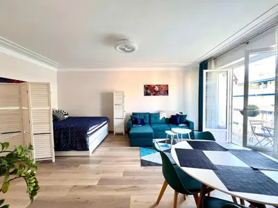 a living room with a bed and a table at B030 Grand studio renove spacieux et lumineux in Le Cannet
