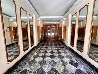 a hallway with mirrors and a checkered floor at B030 Grand studio renove spacieux et lumineux in Le Cannet