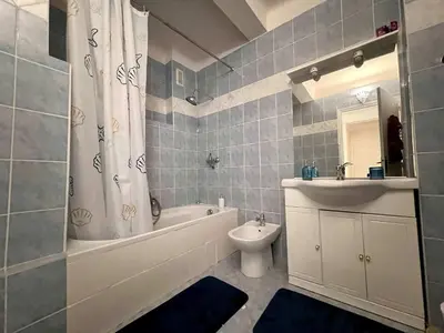 a bathroom with a tub and a sink and a toilet at B030 Grand studio renove spacieux et lumineux in Le Cannet