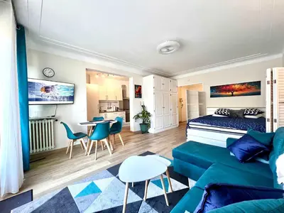 a living room with a bed and a couch at B030 Grand studio renove spacieux et lumineux in Le Cannet