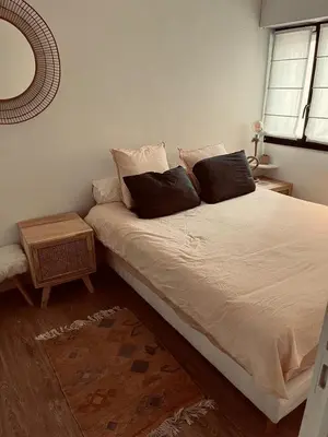 a bedroom with a large bed with two pillows at T3 pièces lumineux à à 1 min de la plage Quartier Palm Beach Cannes in Cannes
