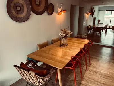 a wooden dining room table with chairs and a table at T3 pièces lumineux à à 1 min de la plage Quartier Palm Beach Cannes in Cannes