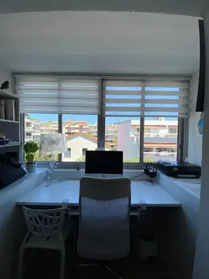 an office with a desk with a laptop and a window at T3 pièces lumineux à à 1 min de la plage Quartier Palm Beach Cannes in Cannes