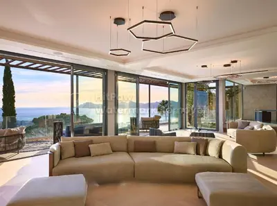 a living room with a large couch and glass windows at Cannes villa 6 chambres - Elisabeth in Cannes