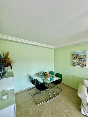 a living room with a table and a couch at 2 pieces proche mer GOLDEN in Cannes
