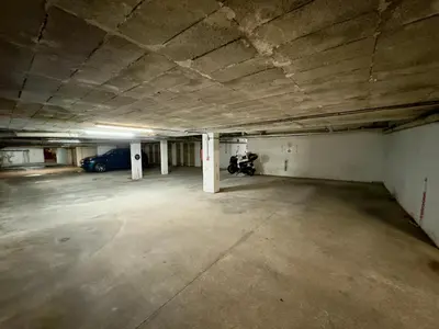 an empty parking garage with a car parked in it at Le Concorde By SCLS Locations in Cannes