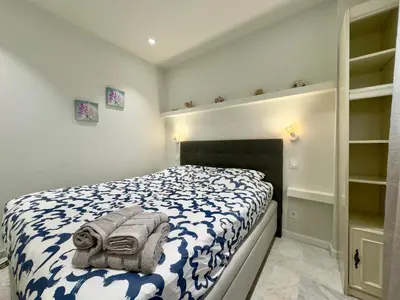 a bedroom with a bed with towels on it at Le Concorde By SCLS Locations in Cannes
