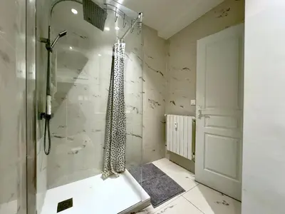a bathroom with a shower with a bath tub at Le Concorde By SCLS Locations in Cannes