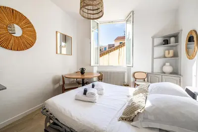 a white bedroom with a bed and a window at 16 FORV - Apartment for 4 people City center - 300m Palais in Cannes