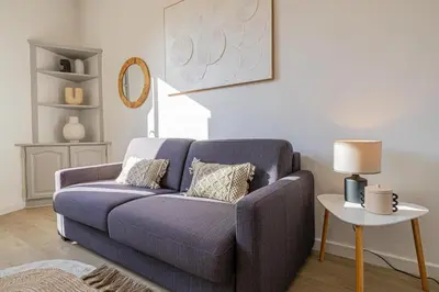 a living room with a blue couch and a table at 16 FORV - Apartment for 4 people City center - 300m Palais in Cannes