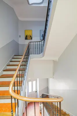 a staircase in a house with white walls and wooden railings at 16 FORV - Apartment for 4 people City center - 300m Palais in Cannes