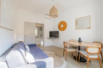 a living room with a blue couch and a table at 16 FORV - Apartment for 4 people City center - 300m Palais in Cannes