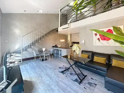 a living room with a couch and a table at Hoche in Cannes