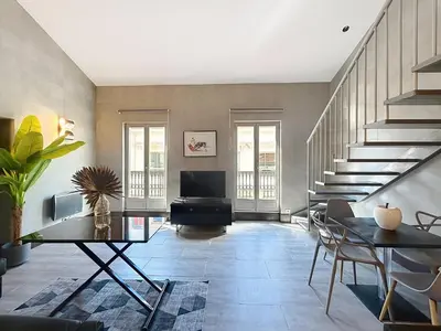 a living room with a staircase and a table at Hoche in Cannes
