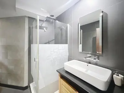 a bathroom with a white sink and a shower at Hoche in Cannes