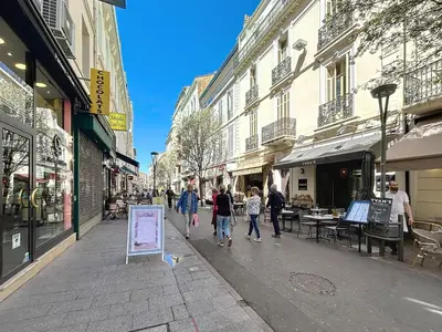 a group of people walking down a street at Hoche in Cannes